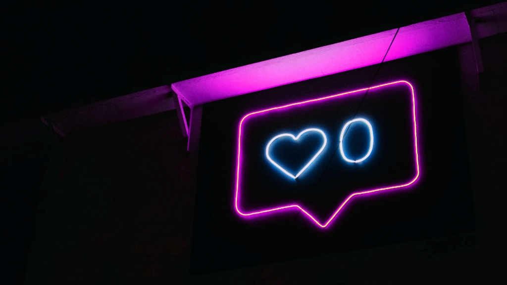 A neon sign displaying a heart and zero, symbolizing social media engagement, perfect for creative professionals seeking dynamic accounting solutions tailored to their digital presence.